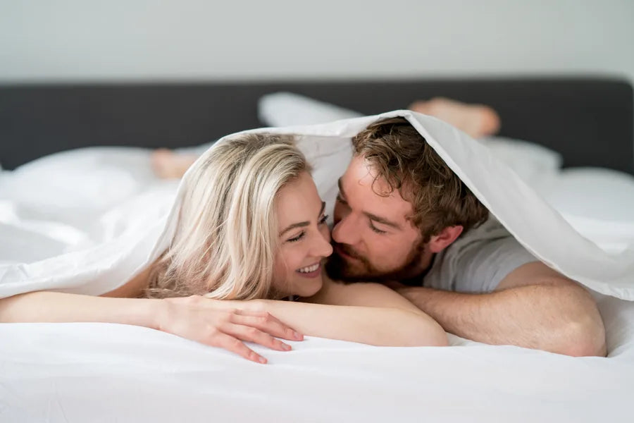 Couple in bed representing private confidence and restored intimacy